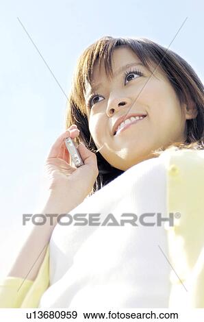 Woman calling by a cell phone View Large Photo Image Stock Photo - Woman calling by a cell phone. Fotosearch