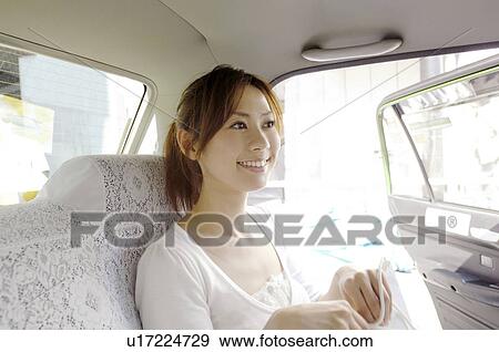 Stock Photo - Woman in the taxi. Fotosearch