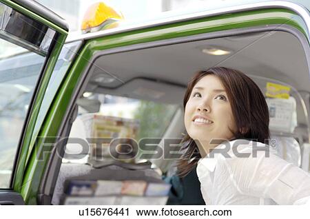 Woman who gets off the taxi View Large Photo Image Stock Image - Woman who gets off the taxi. Fotosearch