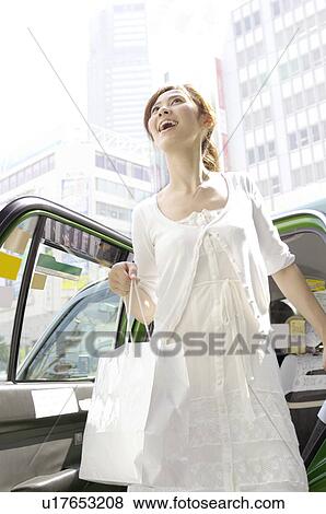 Woman who gets off the taxi View Large Photo Image Stock Photo - Woman who gets off the taxi. Fotosearch