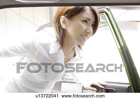 Stock Image - Woman who takes a taxi. Fotosearch