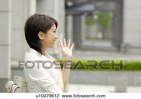 Woman who waves a hand View Large Photo Image Stock Image - Woman who waves a hand. Fotosearch
