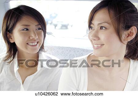 Stock Image - Women in the taxi. Fotosearch