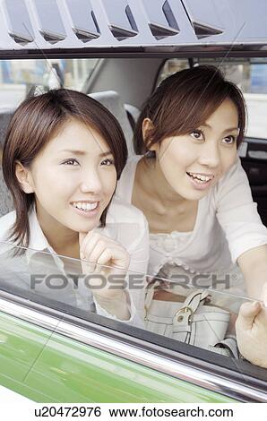 Stock Photograph - Women in the taxi. Fotosearch