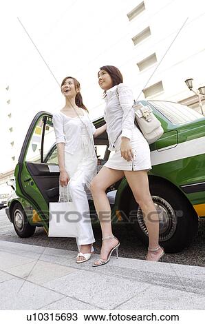Women who got off the taxi View Large Photo Image Stock Image - Women who got off the taxi. Fotosearch
