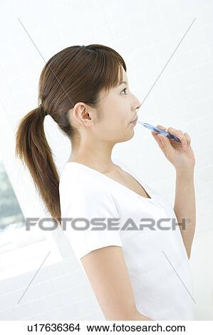 Woman brushing her teeth View Large Photo Image Picture - Woman brushing her teeth. Fotosearch