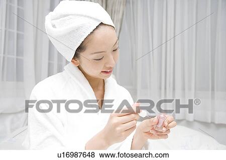 Woman doing care of her nail View Large Photo Image Stock Photo - Woman doing care of her nail. Fotosearch