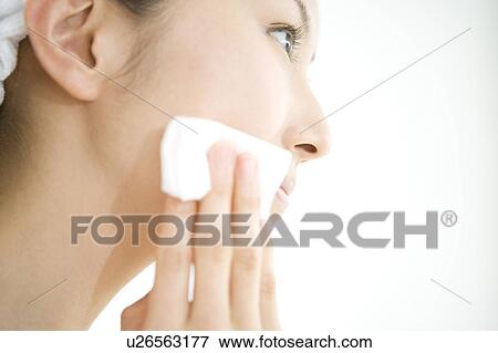 Woman making up her face View Large Photo Image Stock Photo - Woman making up her face. Fotosearch