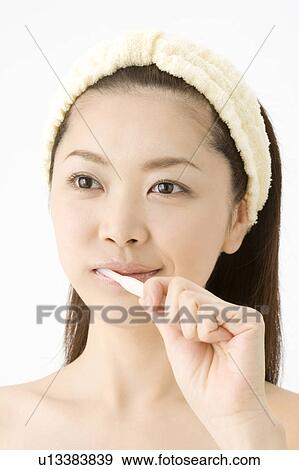 Stock Photo - Woman who brushes her teeth. Fotosearch