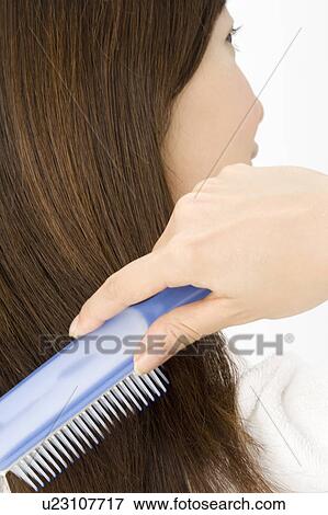 Stock Photo - Woman who combs hair. Fotosearch