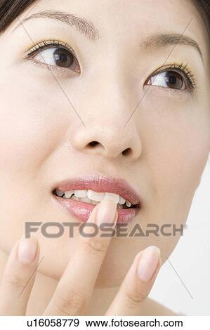 Woman who makes up View Large Photo Image Stock Photo - Woman who makes up. Fotosearch
