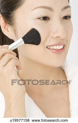 Woman who makes up View Large Photo Image Stock Photo - Woman who makes up. Fotosearch