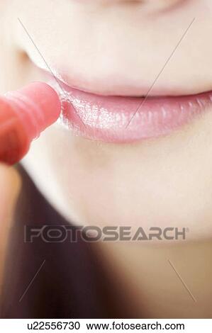 Woman who rouge her lips View Large Photo Image Stock Image - Woman who rouge her lips. Fotosearch