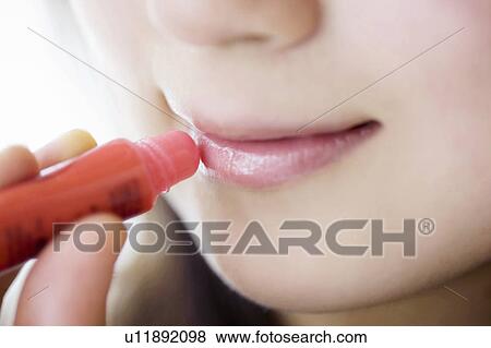 Woman who rouge her lips View Large Photo Image Stock Photo - Woman who rouge her lips. Fotosearch
