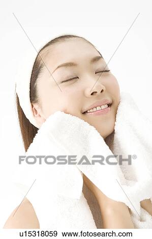 Stock Photo - Woman who wipes a face. Fotosearch
