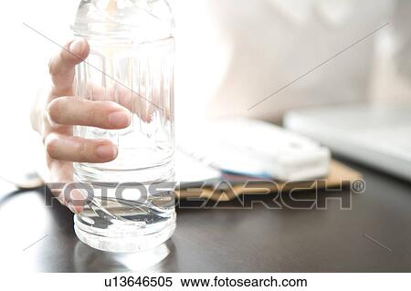 Hand gripping a bottle of water View Large Photo Image Stock Photography - Hand gripping a bottle of water. Fotosearch