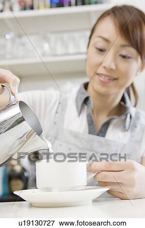 Stock Photo - Sales person in the coffee shop. Fotosearch