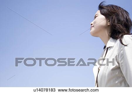 Stock Image - Sky and woman. Fotosearch