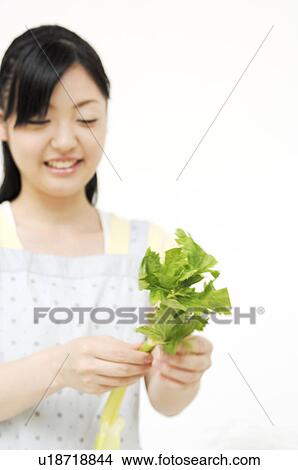 Picture - Woman having celery. Fotosearch
