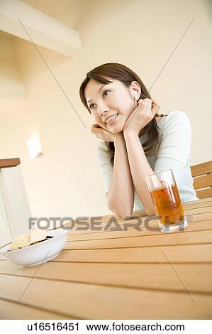 Woman resting her chin in her hands View Large Photo Image Stock Image - Woman resting her chin in her hands. Fotosearch