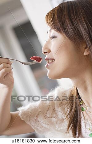 Woman who eats a dessert View Large Photo Image Stock Image - Woman who eats a dessert. Fotosearch