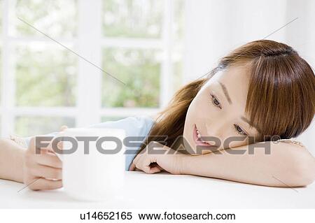 Woman who gazes at the coffee cup View Large Photo Image Stock Photography - Woman who gazes at the coffee cup. Fotosearch
