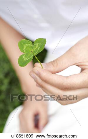 Stock Photo - Woman who has verdure in the hand. Fotosearch