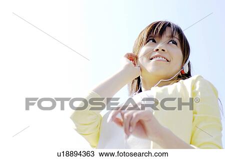 Stock Image - Woman who listens to the music. Fotosearch
