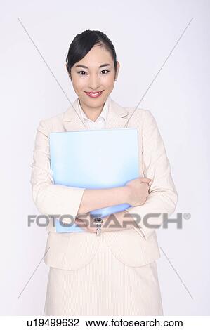 Business lady holding a file with both hands View Large Photo Image Stock Image - Business lady holding a file with both hands. Fotosearch