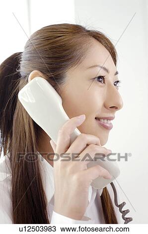 Stock Image - Business lady who does the phone. Fotosearch