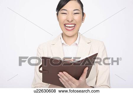 Stock Photo - Business lady who laughs having a notebook. Fotosearch