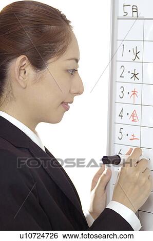 Business lady who writes a schedule View Large Photo Image Stock Photograph - Business lady who writes a schedule. Fotosearch
