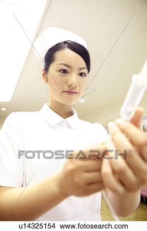 Picture - Nurse checking intravenous feeding. Fotosearch