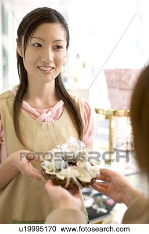 Stock Image - Woman at the flower shop. Fotosearch
