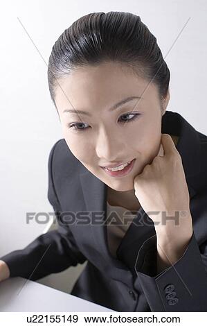 Stock Photo - Woman operating a PC. Fotosearch