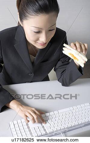 Woman operating a PC View Large Photo Image Stock Photography - Woman operating a PC. Fotosearch