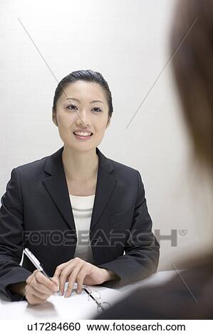Stock Image - Woman who talks a business discussion. Fotosearch