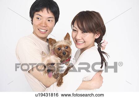 Stock Photograph - Couple and dogs. Fotosearch