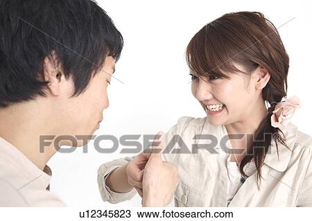 Stock Image - Couple doing finger wrestling. Fotosearch