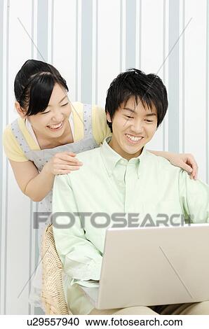 Couple looking at PC View Large Photo Image Stock Image - Couple looking at PC. Fotosearch