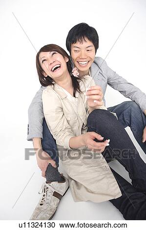 Couple snuggling up to each other View Large Photo Image Stock Image - Couple snuggling up to each other. Fotosearch
