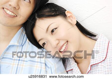 Couple snuggling up to each other View Large Photo Image Stock Image - Couple snuggling up to each other. Fotosearch