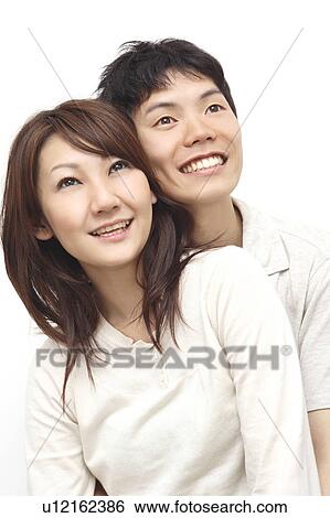 Couple snuggling up to each other View Large Photo Image Stock Photograph - Couple snuggling up to each other. Fotosearch