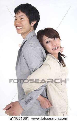 Couple standing back to back View Large Photo Image Stock Image - Couple standing back to back. Fotosearch