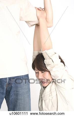 Stock Image - Woman hanging from an arm. Fotosearch