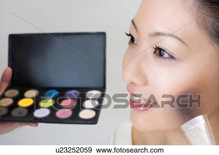 Making up woman View Large Photo Image Stock Photo - Making up woman. Fotosearch