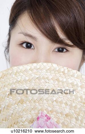 Stock Image - Straw hat and woman. Fotosearch
