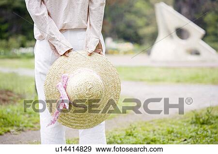 Stock Photo - Straw hat and woman. Fotosearch