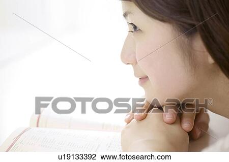 Stock Image - Woman reading a book. Fotosearch