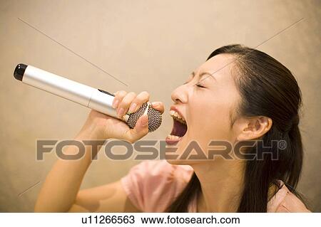 Woman who does karaoke View Large Photo Image Stock Image - Woman who does karaoke. Fotosearch